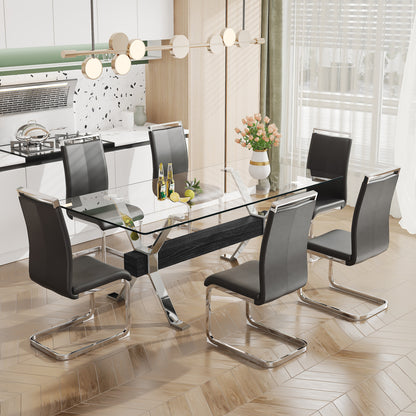 Modern tempered glass dining table with silver plated metal legs.