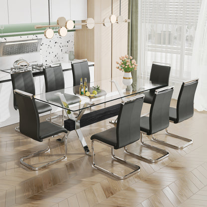 Modern tempered glass dining table with silver plated metal legs.