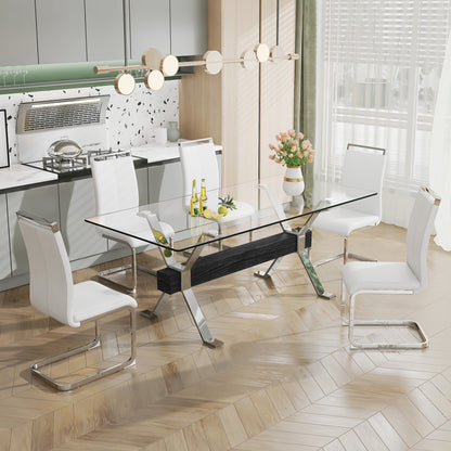 Modern tempered glass dining table with silver plated metal legs.